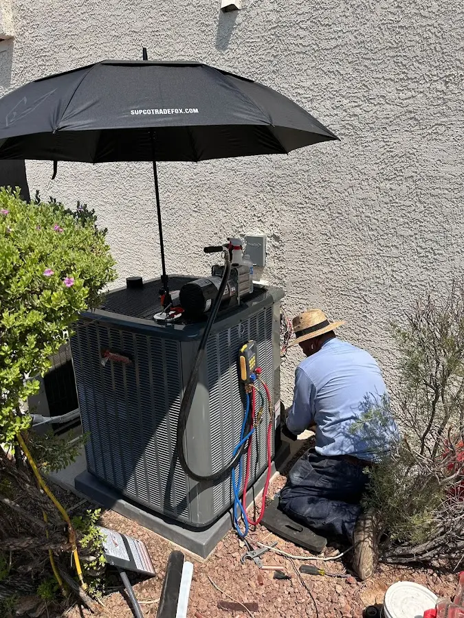 HVAC technician performing outdoor AC maintenance in Fremont